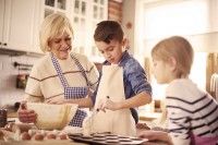 little-boy-baking-beetwen-ladies